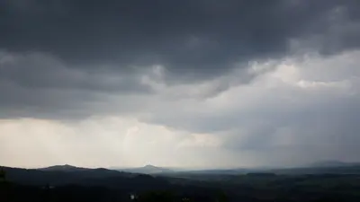 Storm light over the Jičín basin from Brada, Trosky in the distance